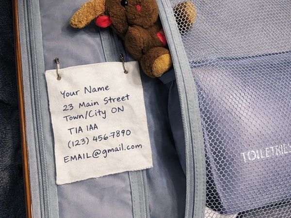 Inside view of suitcase with emergency contact label in case outer baggage tag is lost.