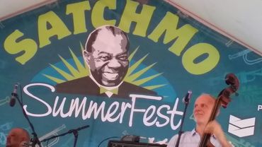 A musician plays double bass on stage at the Satchmo SummerFest.