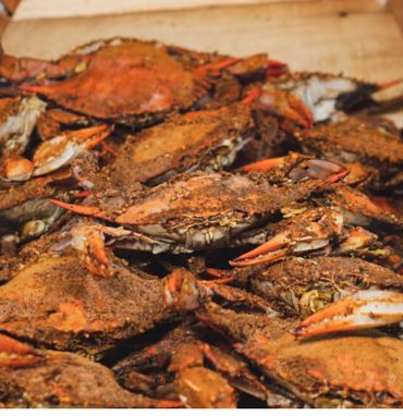 Pile of seasoned cooked crabs ready to eat.