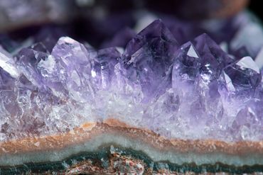 Close-up of a vibrant purple amethyst crystal cluster.