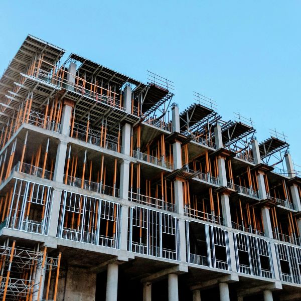 Under-construction multi-story building with scaffolding.