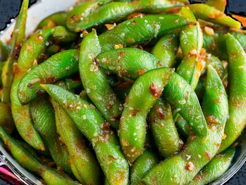 Bowl of spicy garlic edamame with sea salt.