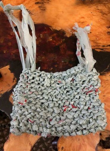 A bag woven from single use plastic bags.