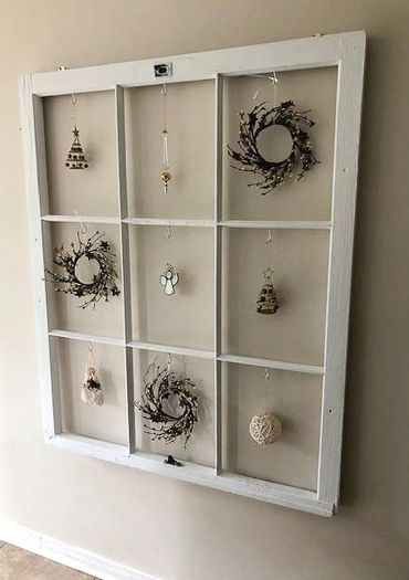A large white frame displaying a variety of brown and white ornaments.