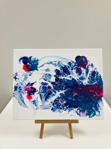Pour art using pink, blue and white paint.