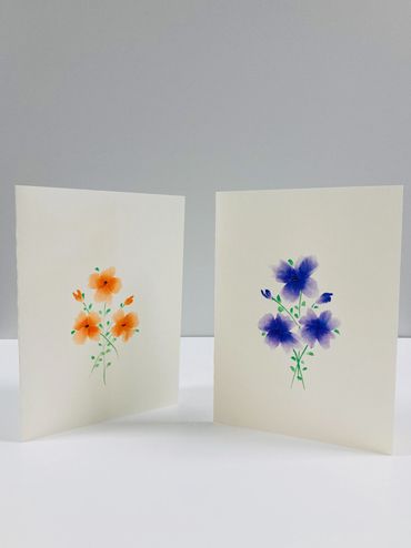 Two card designs featuring watercolor flowers.