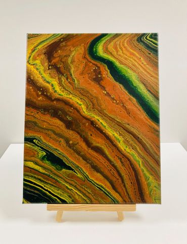 A pour painting with green, orange and yellow swirls.