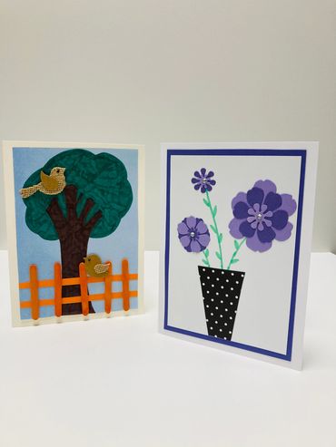 Two cards, one featuring purple flowers and the other a tree with birds.