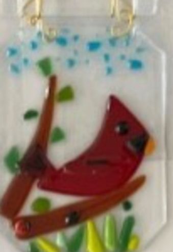 A fused glass ornament featuring a robin.