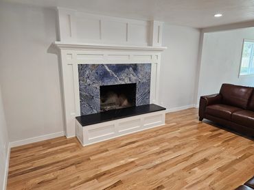 Custom built and finished mantle and hearth. New 3 1/4" #2 common white oak hardwood floors