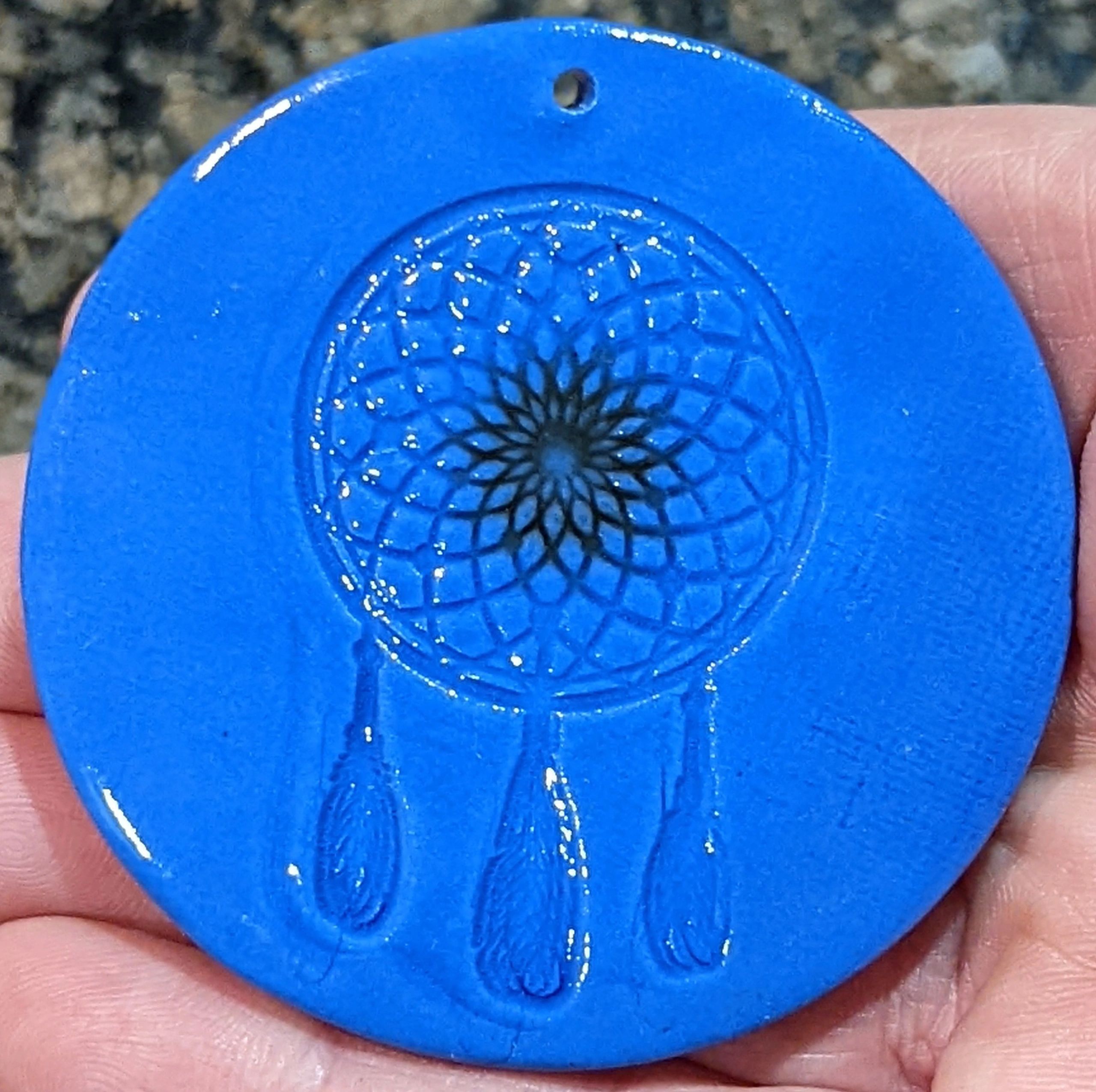Dream catcher imprinted on blue porcelain, the center has just a touch of black