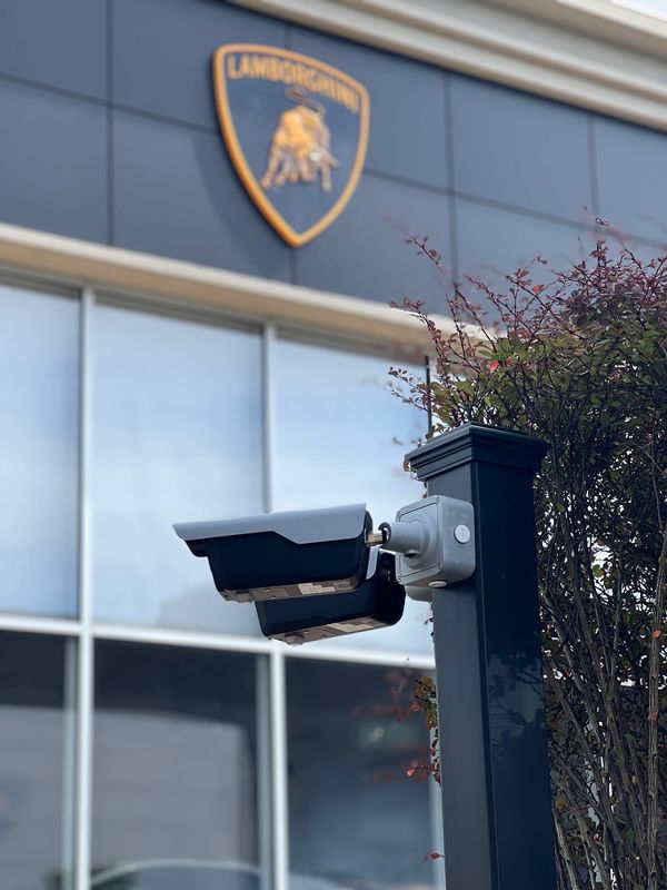 Security cameras monitoring outside a Lamborghini dealership.