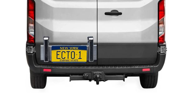 Rear view of a white van with a New York license plate reading ECTO-1.