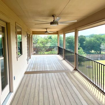 Austin, TX  2nd story home balcony extension with wood decking, iron railing for safety and fans ins