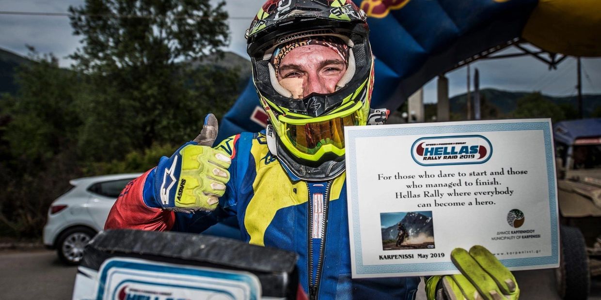Motocross rider proudly shows certificate after Hellas Rally 2019.