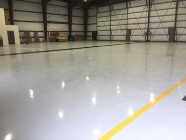 Empty, clean industrial space with polished floor and yellow line.