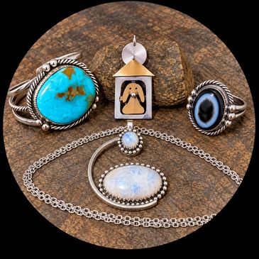 photo showing the range of work including bracelet, pendants, and ring.