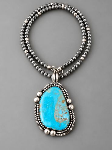 Turquoise stone set in sterling silver with beads and twist wire accents. Also a 5mm strand of sterling silver beads