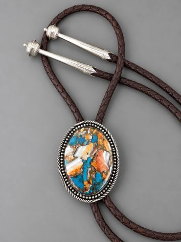 Sterling silver bolo tie with turquoise and spiny oyster composite stone and decorative silver tips.