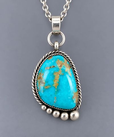 Handcrafted sterling silver pendant with bright blue turquoise cabochon, natural matrix, twisted wir