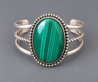 Handcrafted sterling silver cuff with oval green banded malachite, beaded silver border, and polishe