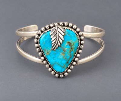 Handcrafted sterling silver cuff with triangular Kingman turquoise, beaded silver border, leaf accen