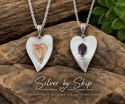 Two handcrafted heart pendants: sterling silver, copper and brass tri-heart, and sterling silver hea