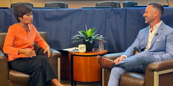 Two people in a casual interview setting.