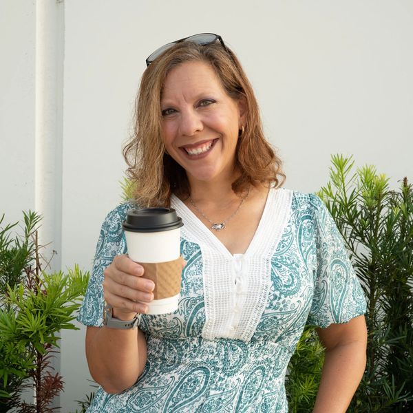 Realtor holding a cup of coffee