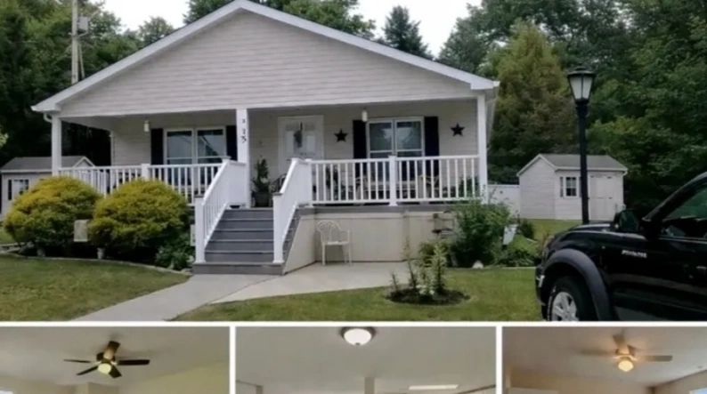 White house with porch and black shutters.