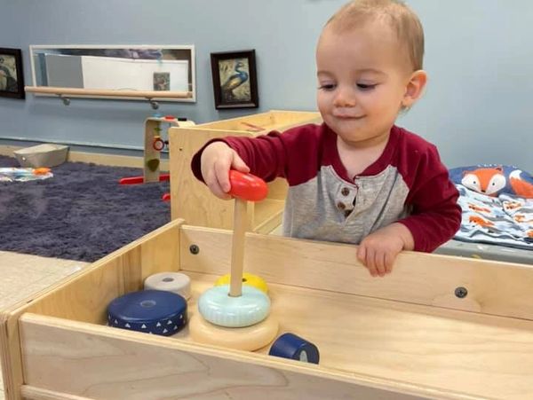 A picture of the small boy playing with toys