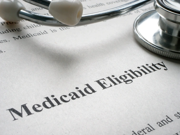 Document titled 'Medicaid Eligibility' with a stethoscope on top.
