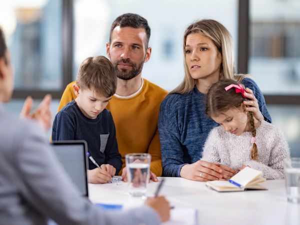 A family meeting with a counselor, showing concern and attentiveness.