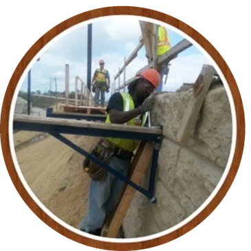 Construction workers building a stone wall.