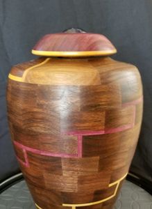 On this vessel, the primary wood is walnut and the accent (highlight) colors are padauk & maple