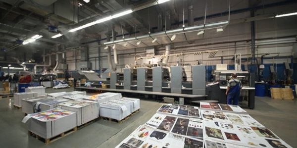 Inside image of an offset print factory along with workers