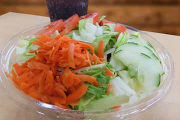 garden salad filled with iceberg lettuce tomatoes cucumbers and carrots