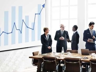 Business professionals discussing growth in a modern conference room.
