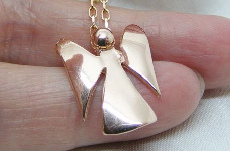 An angel pendant made from 9ct rose gold. the angel is slightly curved and fully hallmarked
