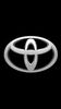 Silver Toyota logo on a black background.