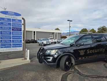 Security SUV parked near a business directory sign at 2900 Louisiana North Building.