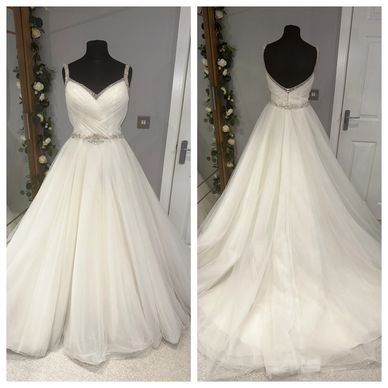 Elegant white wedding dress on a mannequin, front and back views.
