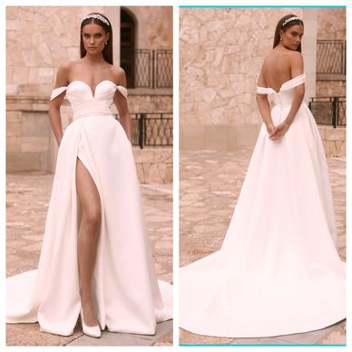 Elegant off-shoulder white bridal gown with thigh-high slit and long train.