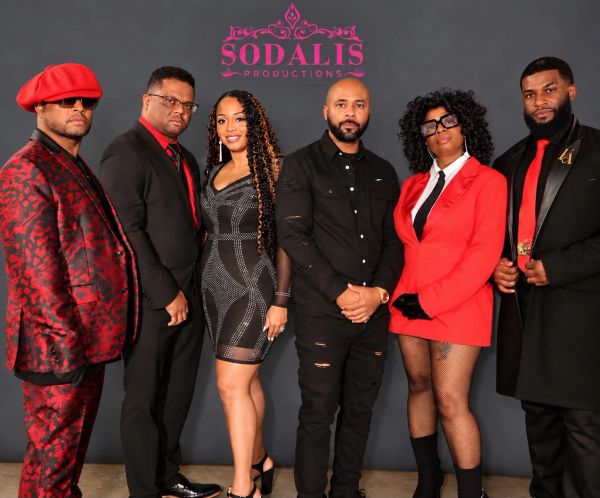 A stylish group of six individuals posing together with Sodalis Productions logo.
