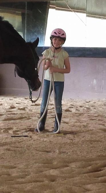 Young girl with her lesson horse