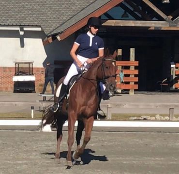 Riding a canter circle at a dressage schooling show