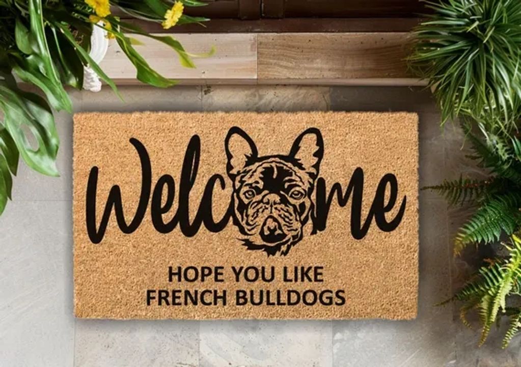Welcome mat with a French Bulldog illustration and text.