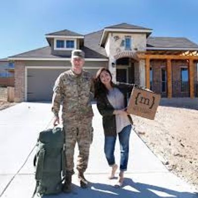 Military family standing in front of house. Your Hampton movers proudly support military families. 