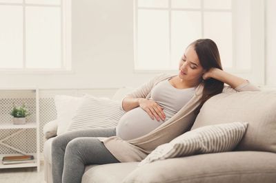 Pregnant mum relaxing on a sofa