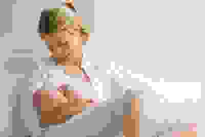 Happy and relaxed mum breastfeeding her baby